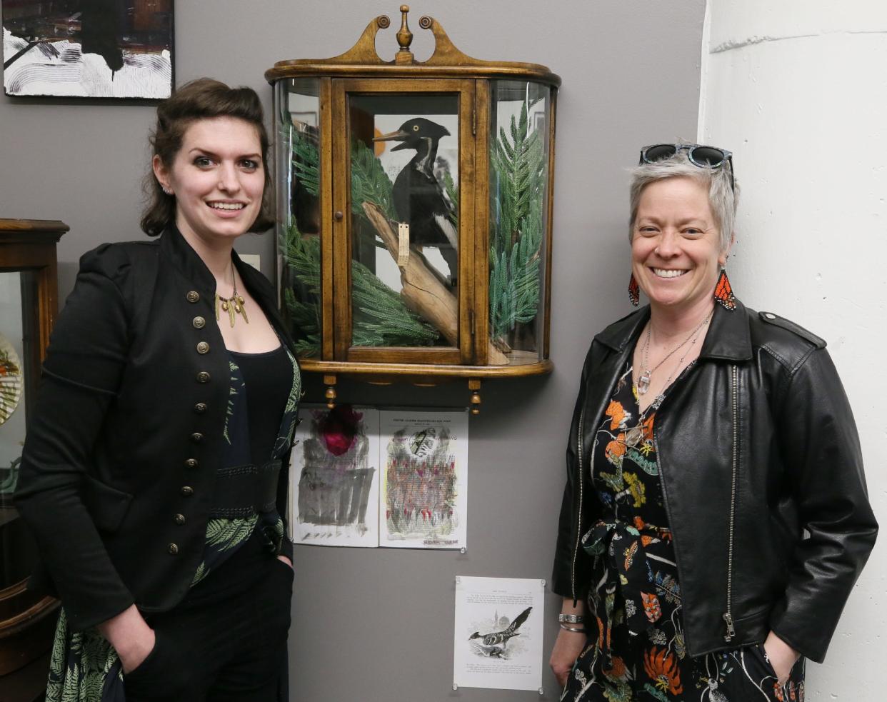 Taxidermist Maria Burke and Lara Roketenetz, director of University of Akron Field Station, pose with the critically endangered ivory-billed woodpecker from the 100-year-old Rhodes Collection bird collection at University of Akron's Cummings Center.