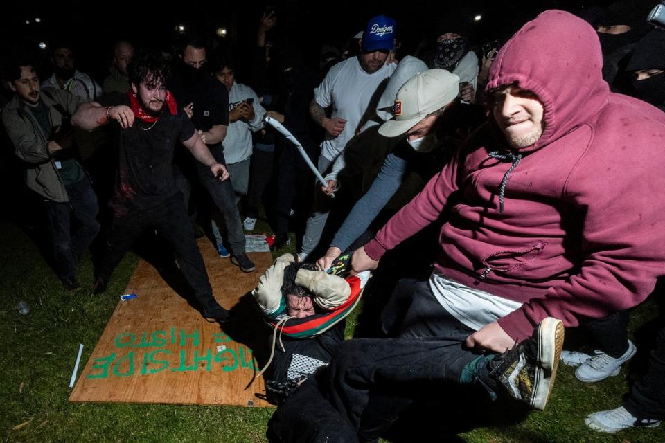 A pro-Palestinian demonstrator is beaten by counter protesters on the UCLA campus (AFP/Getty)