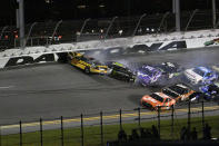 Ryan Blaney (12), Ty Gibbs (54) and Christopher Bell (20) collide, beginning a multi-car wreck in Turn 4 during the NASCAR Cup Series auto race at Daytona International Speedway, Saturday, Aug. 26, 2023, in Daytona Beach, Fla. (AP Photo/Phelan M. Ebenhack)