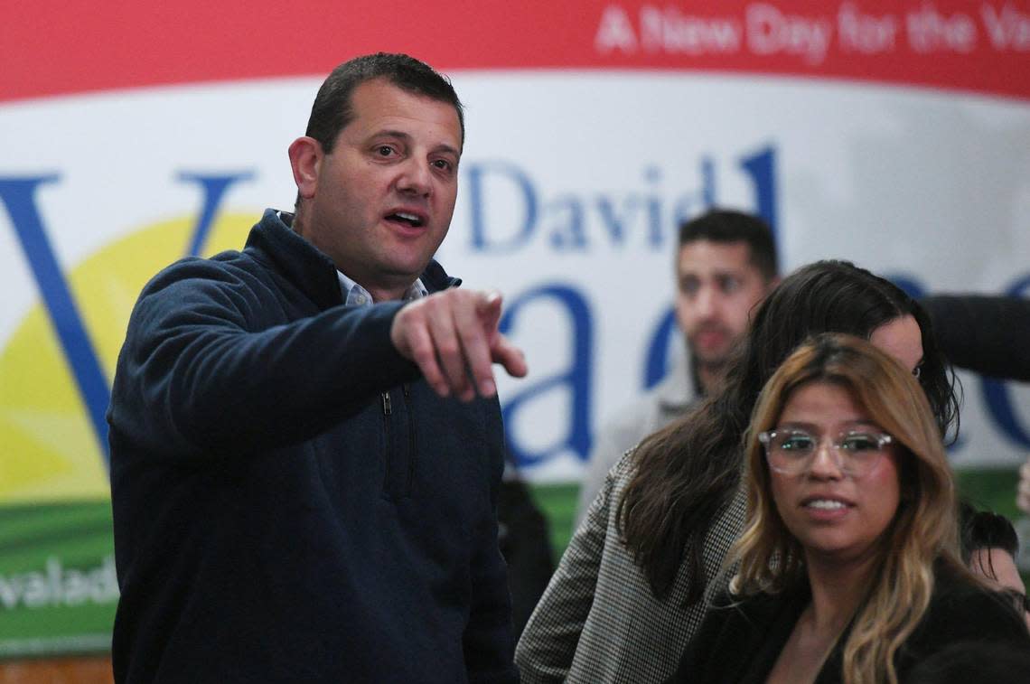 David Valadao, candidate for the 22nd Congressional District, left, points to election results on two monitors across the room as a supporter stands to the right at his election night gathering Tuesday, Nov. 8, 2022 near Hanford.