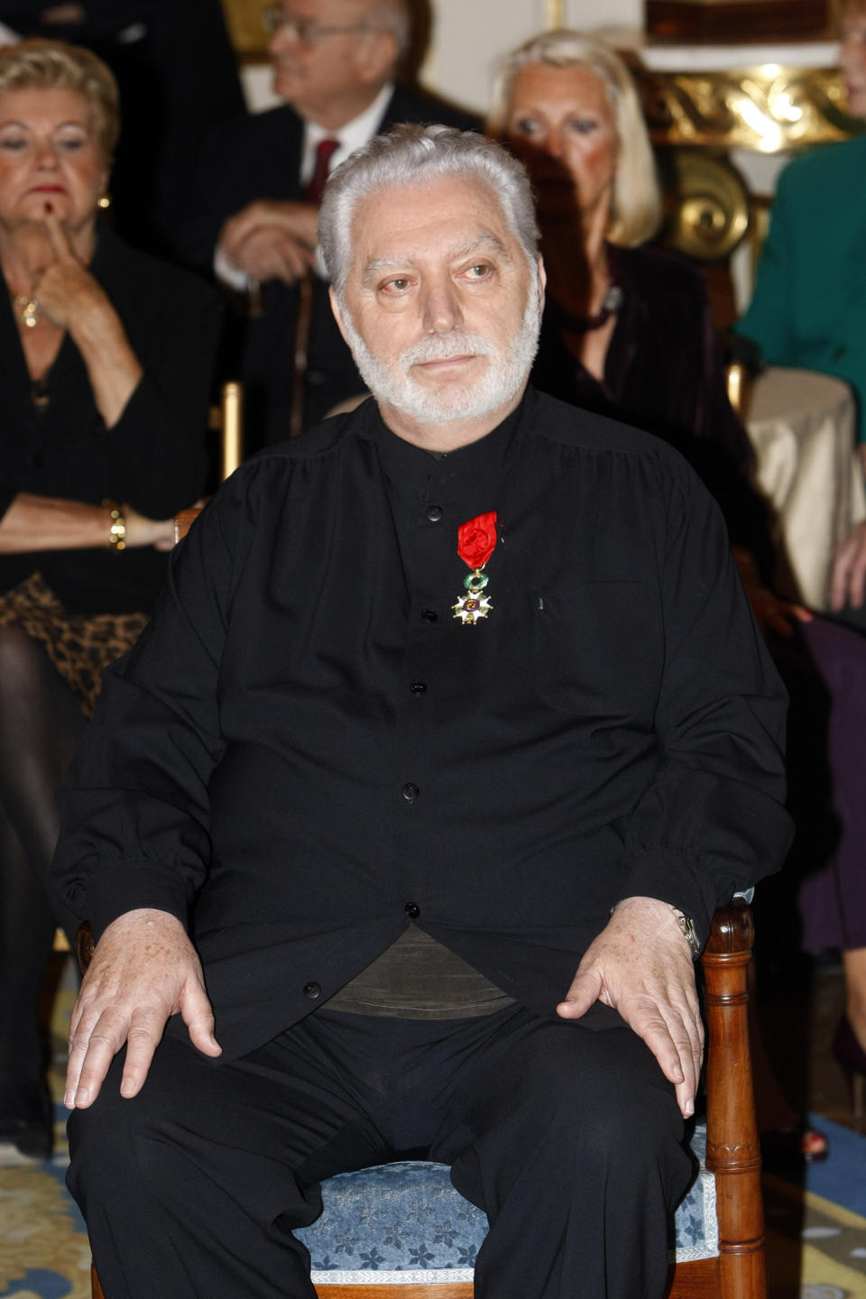 FILE - Fashion designer Paco Rabanne sits after being awarded the Legion of Honor by French Culture Minister Frederic Mitterrand in on April 16, 2010 Paris. The Spanish-born pace-setting designer known for perfumes sold worldwide and his metallic, space-age fashions, has died, the group that owns his fashion house announced on its website Friday Feb.3, 2023. He was 88. (AP Photo/Jacques Brinon, File)