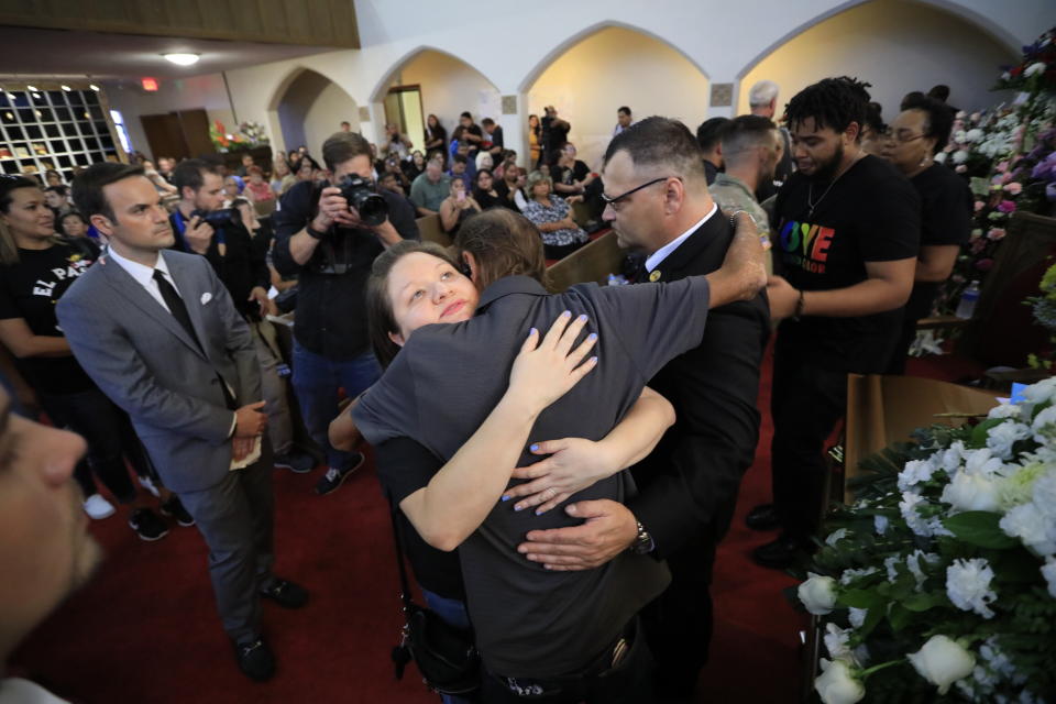 Heartwarming: People offer condolences to Mr Basco, center.  (AP) Hundreds attended the service