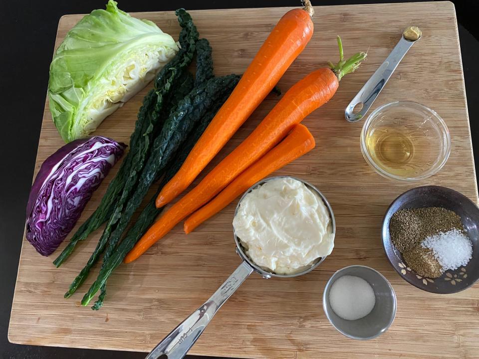 Vegetables and herbs on a cutting board.