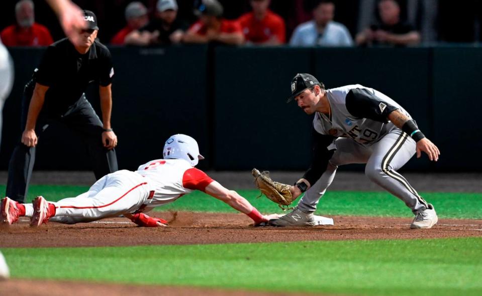 N.C. State’s Luke Nixon (0) avoids the tag by Bryant’s Carmine Petosa (19) during N.C. State’s 9-2 victory against Bryant in the NCAA Raleigh Regional at Doak Field on Friday, May 31, 2024.