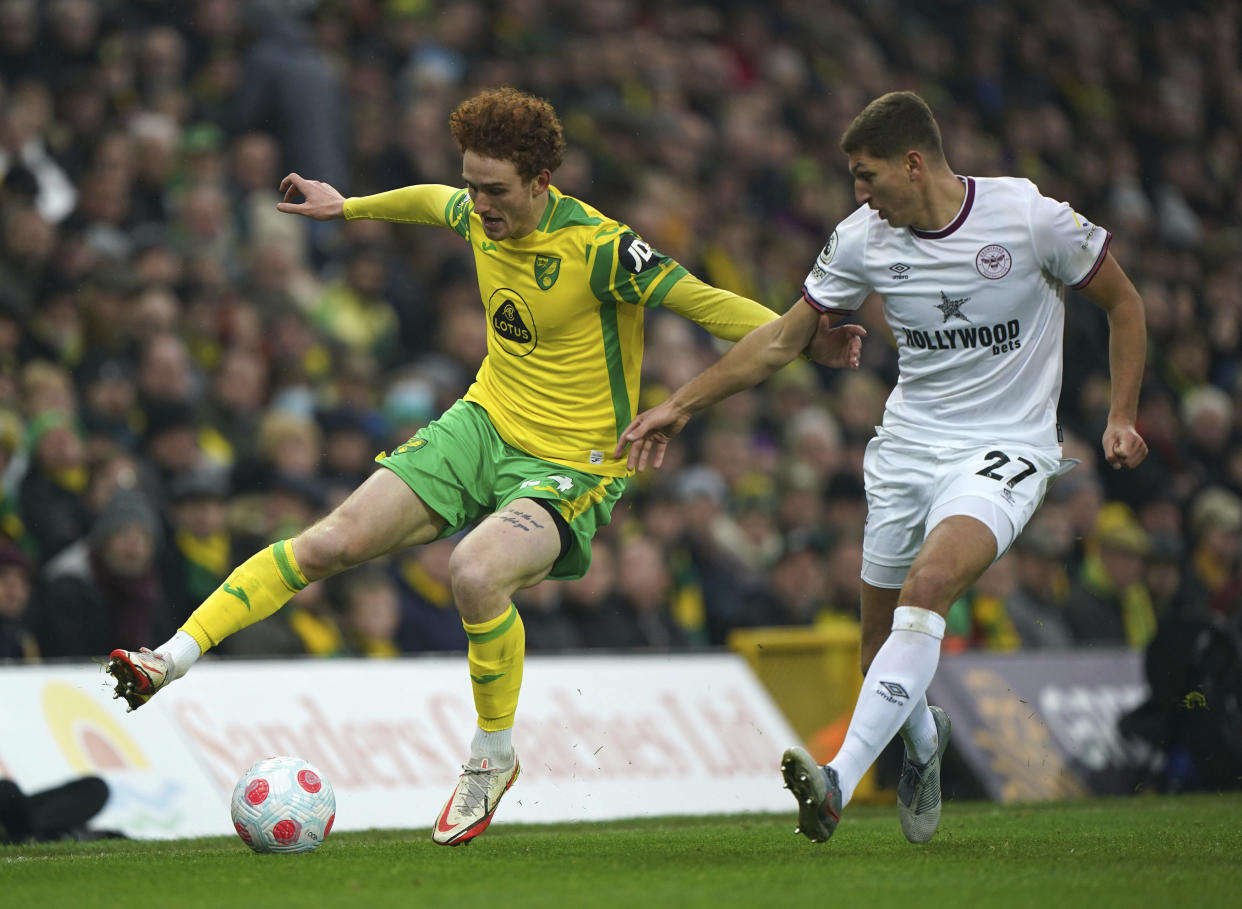 Norwich City's Josh Sargent and Brentford's Vitaly Janelt, right, battle for the ball during the English Premier League soccer match between Norwich City and Brentford at Carrow Road, Norwich, England, Saturday March 5, 2022. (Joe Giddens/PA via AP)