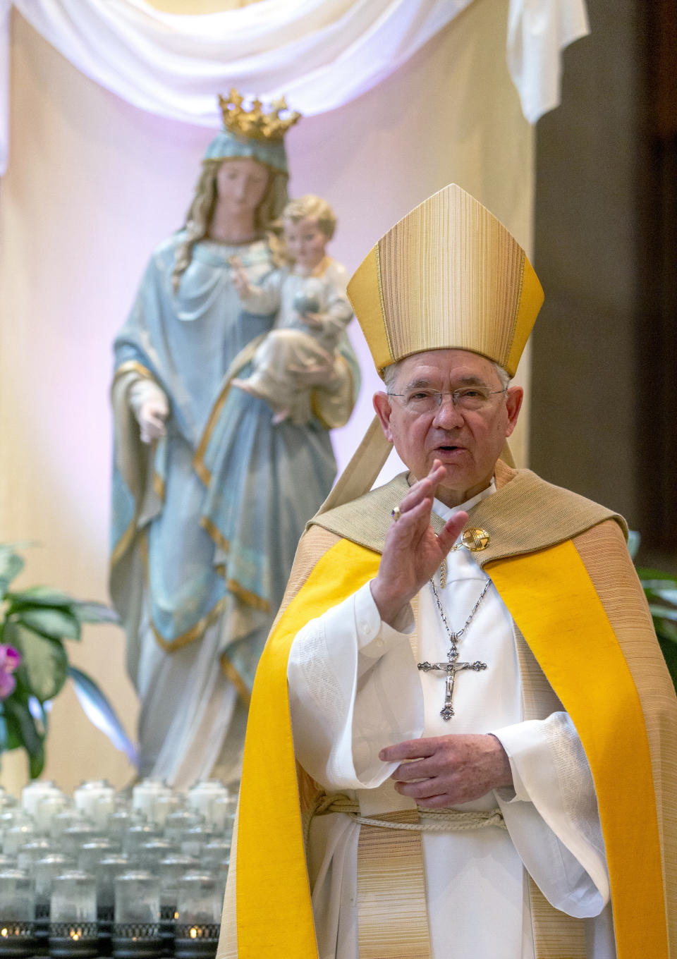 FILE - In this Friday, May 1, 2020 file photo, Archbishop Jose H. Gomez gives a blessing after leading a brief liturgy at the Cathedral of Our Lady of the Angels in Los Angeles. Gomez heads the U.S. Conference of Catholic Bishops, which paid $20,000 to lobby the U.S. Senate and House on “eligibility for non-profits” in a landmark coronavirus relief law. (AP Photo/Damian Dovarganes, Pool)