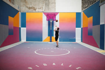 The basketball court Pigalle Duperre, painted in shades of purple, pink, yellow, orange and blue, and with a rubber-surfaced court, is sandwiched into a row of buildings in the 9th arrondissement, is pictured in Paris, France, July 31, 2018. REUTERS/Benoit Tessier