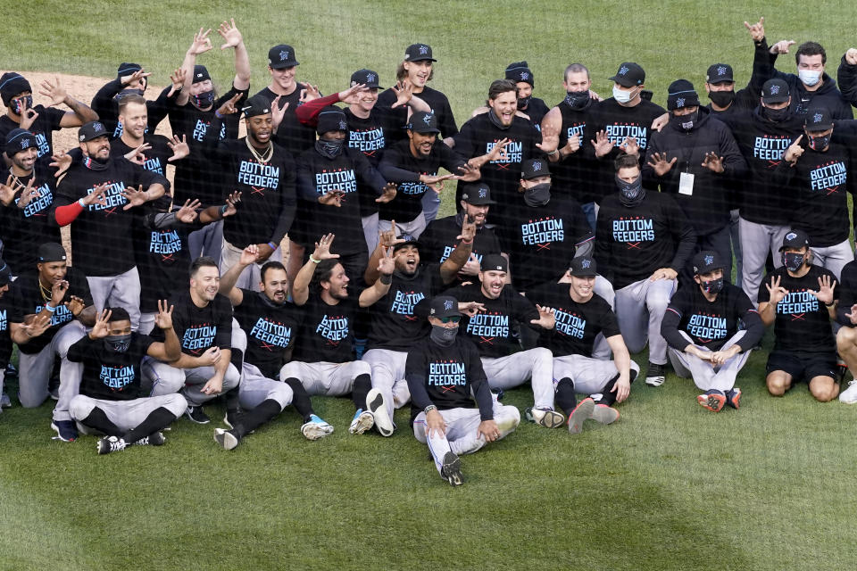 Members of the Miami Marlins celebrate after defeating the Chicago Cubs in Game 2 of a National League wild-card baseball series Friday, Oct. 2, 2020, in Chicago. The Marlins won the series 2-0 to advance to the division series. (AP Photo/Nam Y. Huh)