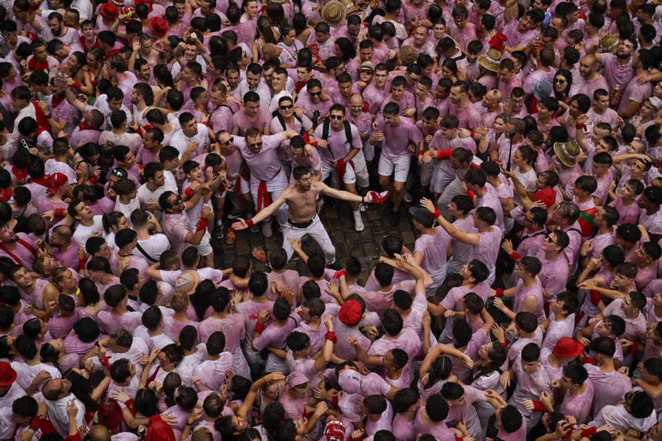Revellers dressed in red and white fill the town hall square during the 'Chupinazo' rocket, which marks the official opening of the 2023 San Fermín fiestas in Pamplona, Spain, Thursday, July 6, 2023. (AP Photo/Alvaro Barrientos)