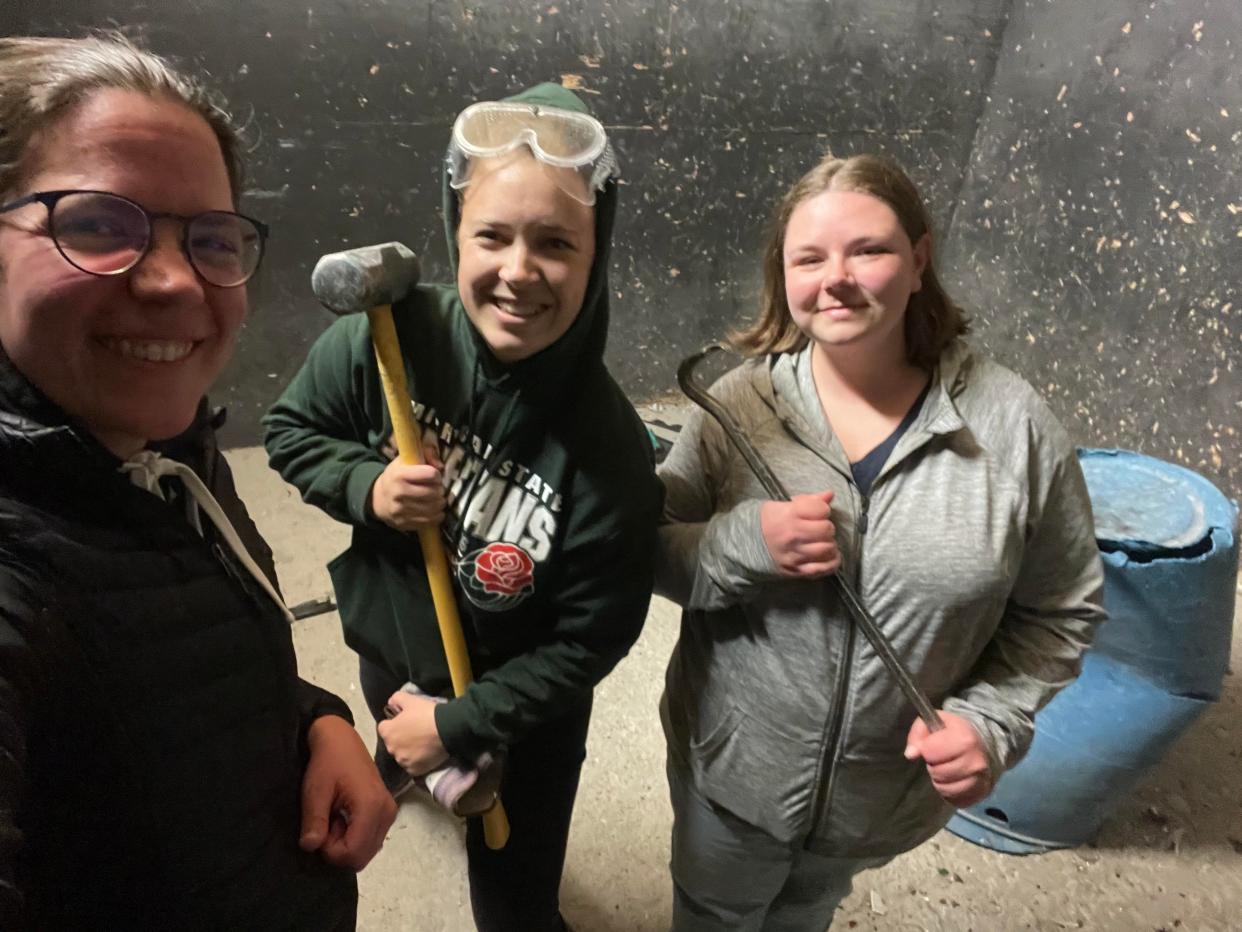 Three woman in a "rage room"