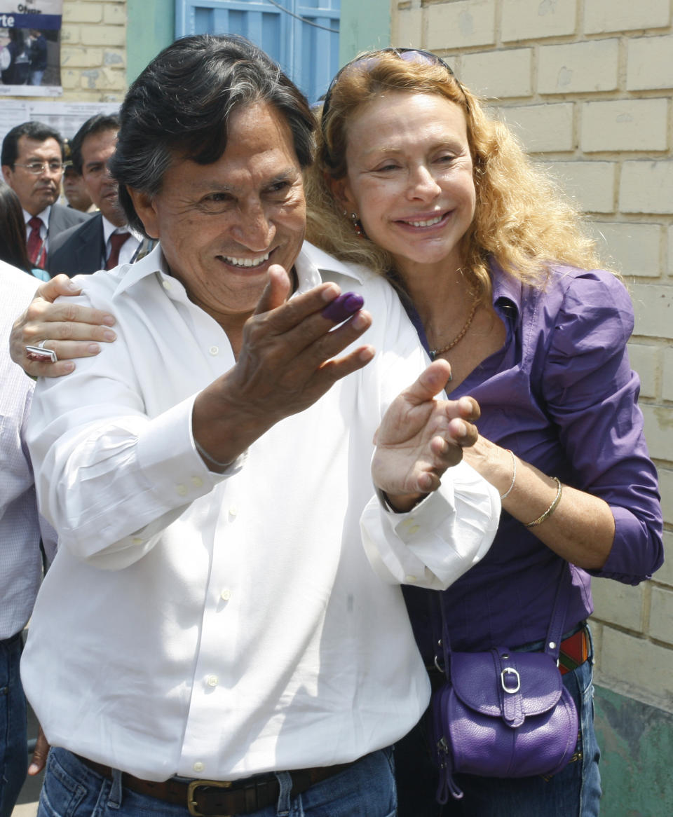 FILE - In this April 10, 2011 file photo Presidential candidate Alejandro Toledo, accompanied by his wife Eliane Karp, greet supporters outside a polling station after casting his ballot in the general elections in Lima, Peru. A federal judge in San Francisco has denied bail to former Peruvian President Toledo in an extradition hearing that ended with an emotional outburst by his wife who had to be dragged out of the courtroom after she started shouting at prosecutors. (AP Photo/Juan Diego Contreras,File)