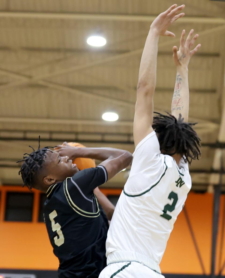 Midwest City's Deshawn Denson II shoots as Norman North's Tracy Leslie defends during the Putnam City Invitational boys championship basketball game between Midwest City and Norman North at Putnam City High School in Oklahoma City, Saturday, Jan. 6, 2024.