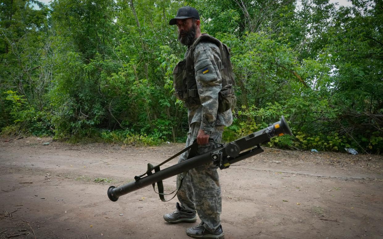 A Ukrainian soldier carries a US-supplied Stinger, as Nato warns of the need to keep supplying the defenders with weapons - AP Photo/Efrem Lukatsky