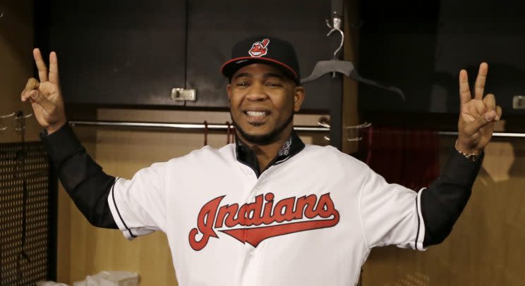 Cleveland Indians' Edwin Encarnacion smiles wearing a Cleveland Indians baseball jersey, Thursday, Jan. 5, 2017, in Cleveland. One win from a World Series title last season, the Indians finalized a $60 million, three-year contract with free agent slugger Encarnacion. (AP Photo/Tony Dejak)