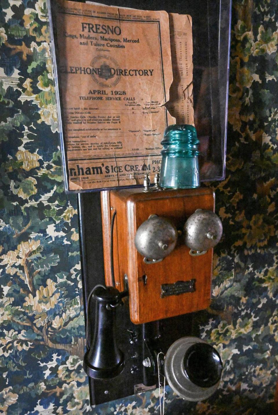 An old telephone hangs on the wall of the Meux home along with 1928 Fresno telephone directory that includes Dr. Thomas Meux’s phone number.