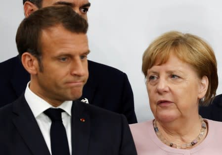 FILE PHOTO: France's President Emmanuel Macron and Germany’s Chancellor Angela Merkel during a news conference at the G20 summit in Osaka