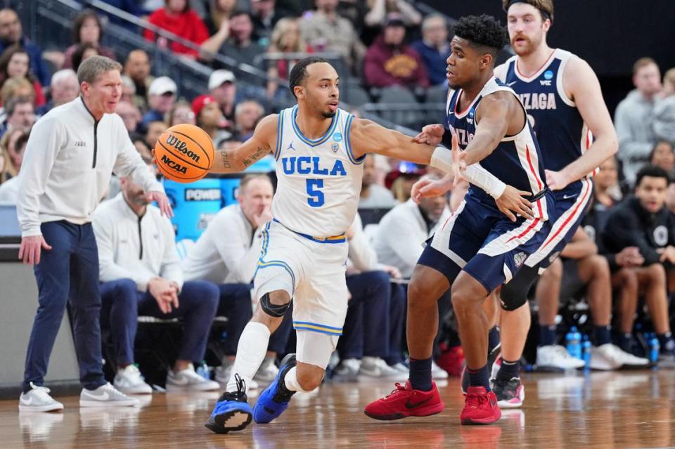 Mar 23, 2023; Las Vegas, NV, USA; UCLA Bruins guard Amari Bailey (5) dribbles the ball against Gonzaga Bulldogs guard Malachi Smith (13) during the first half at T-Mobile Arena. Mandatory Credit: Joe Camporeale-USA TODAY Sports