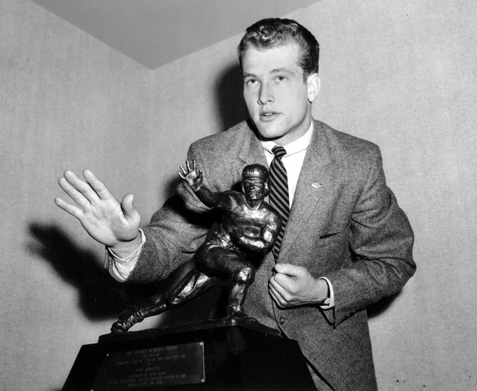 File-This Dec. 12. 1956, file photo shows Notre Dame quarterback Paul Hornung imitating the posture of the Heisman Trophy that he received at the Downtown Athletic Club in New York City. . (AP Photo, File)