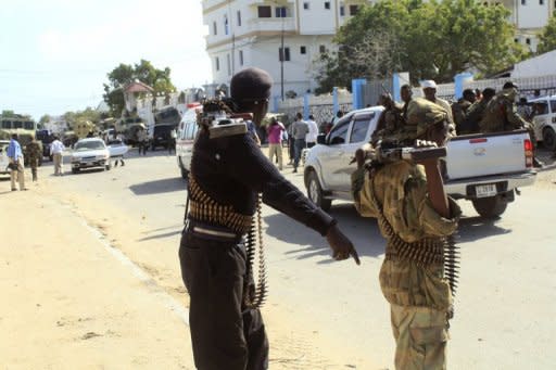 AMISOM (African Union Mission in Somalia) patrol the area of a bomb blast, claimed by Islamist rebels, that rocked a Mogadishu hotel where the newly elected Somali president Hassan Sheikh Mohamud was staying