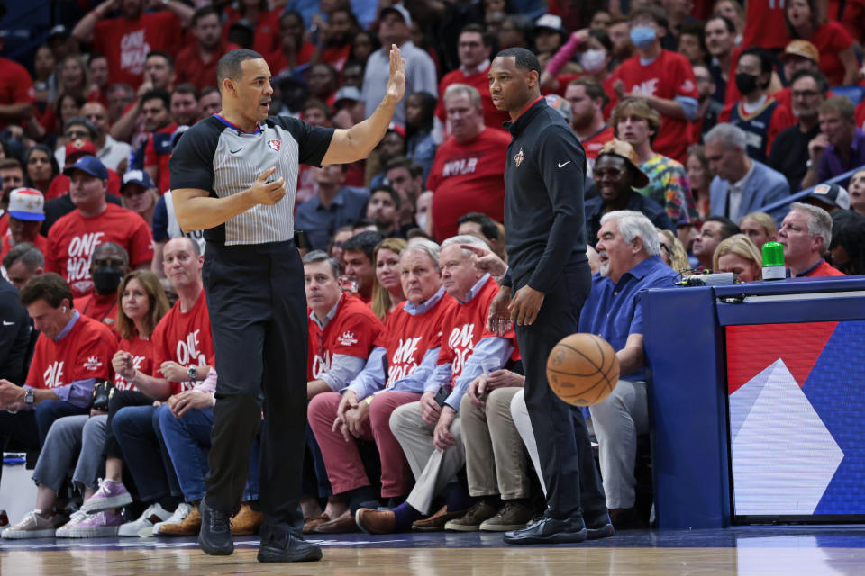 New Orleans Pelicans coach Willie Green watches as a foul is called against a Pelicans player during the first half of Game 3 of the team's NBA basketball first-round playoff series against the Phoenix Suns in New Orleans, Friday, April 22, 2022. (AP Photo/Michael DeMocker)