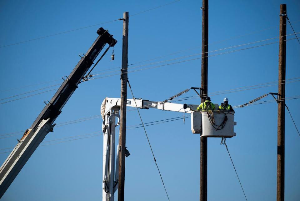 Linemen work on repairing electrical lines Friday, March. 1, 2024, near Stinnett, Texas.