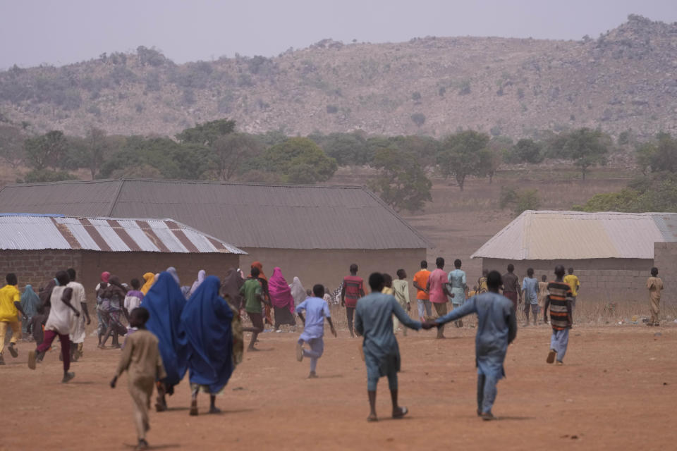 Children run in celebration after a false alarm that kidnapped LEA Primary and Secondary School students of Kuriga had been released in Kaduna state, Nigeria, Saturday, March 9, 2024. The kidnapping on Thursday was only one of three mass kidnappings in northern Nigeria since late last week, a reminder of the security crisis that has plagued Africa's most populous country. No group claimed responsibility for any of the abductions but two different groups are blamed. (AP Photo/Sunday Alamba)