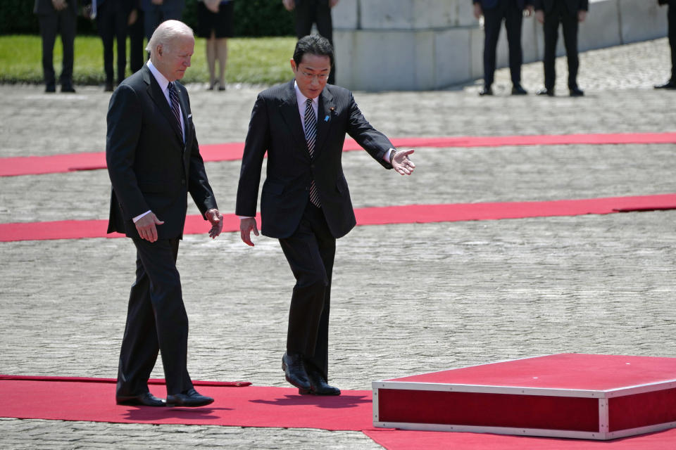 U.S. President Joe Biden, left, is escorted by Japan's Prime Minister Fumio Kishida during a welcome ceremony for President Biden, at the Akasaka Palace state guest house in Tokyo, Japan, Monday, May 23, 2022. (AP Photo/Eugene Hoshiko, Pool)