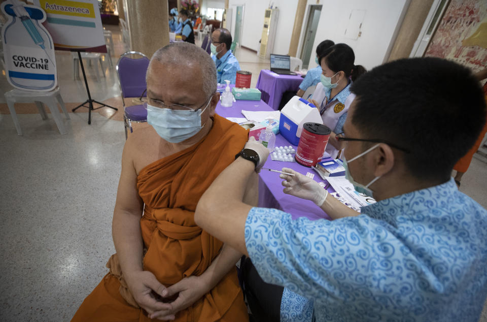 A health worker administers a dose of the AstraZeneca COVID-19 vaccine to a Buddhist monk at Nak Prok Temple in Bangkok, Thailand, Friday, April 9, 2021. (AP Photo/Sakchai Lalit)