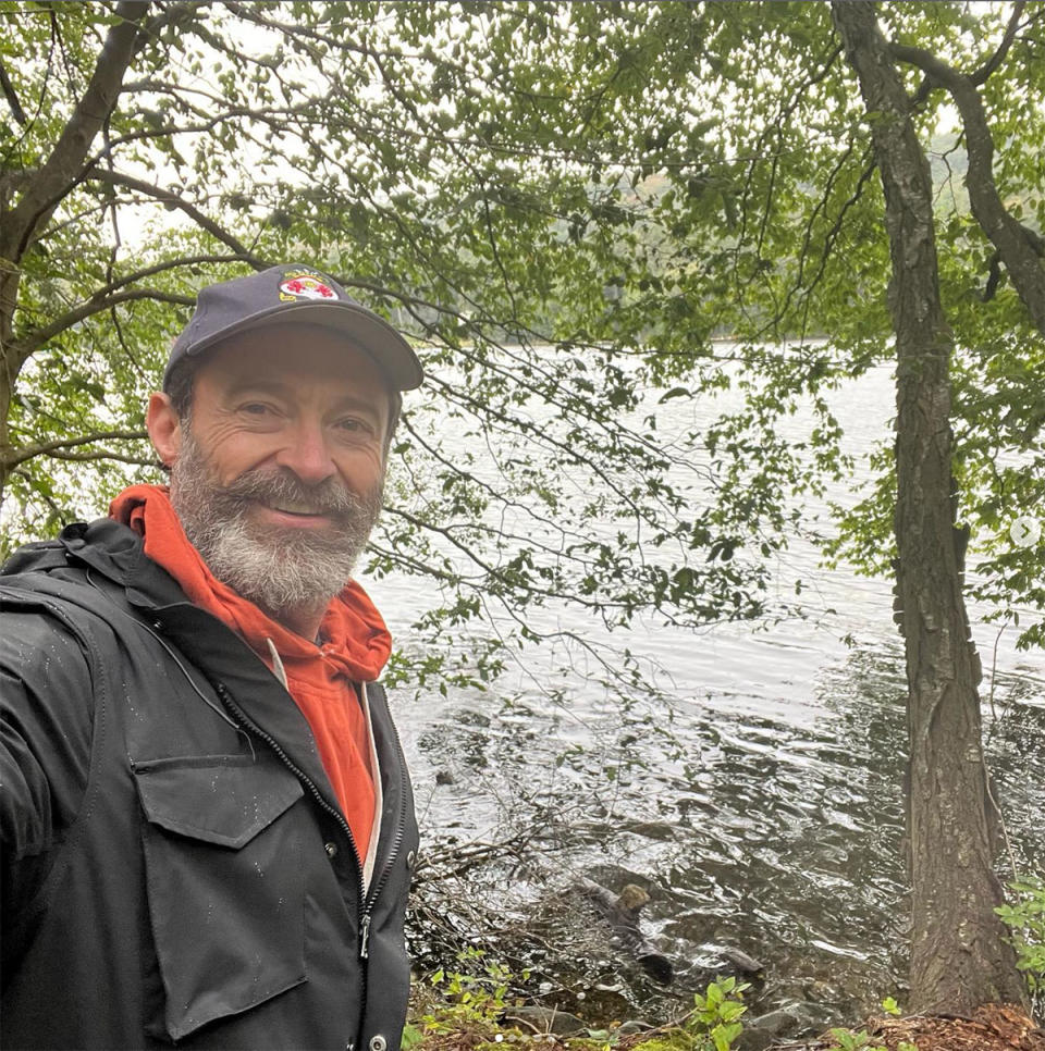 Hugh Jackman in a park wearing a Wrexham AFC cap