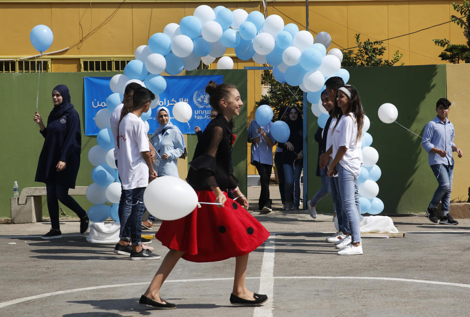 Palestinian refugee students attend a ceremony to mark the return to school of a new year at one of the UNRWA schools, in Beirut, Lebanon, Monday, Sept. 3, 2018. The United Nations' Palestinian relief agency celebrated the start of the school year in Lebanon on Monday, managing to open its schools on schedule despite a multi-million dollar budget cut on the heels of U.S. President Donald Trump's decision to stop funding to the agency. (AP Photo/Hussein Malla)