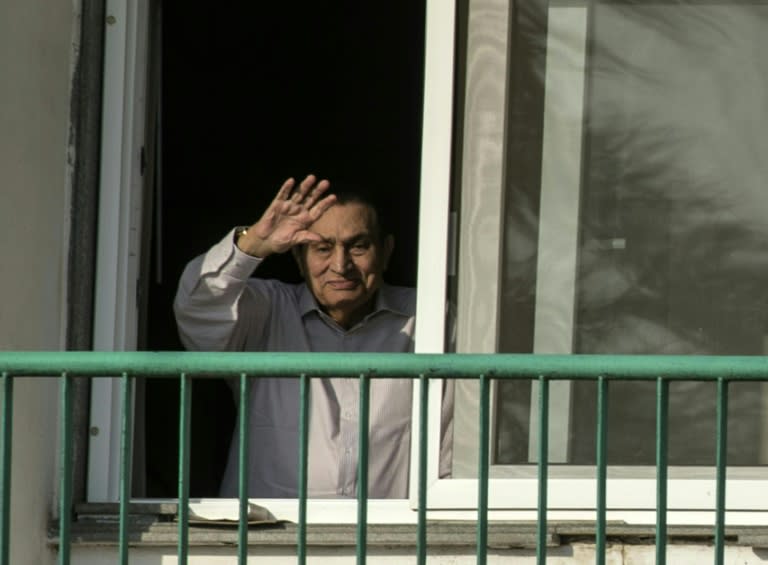 Former Egyptian president Hosni Mubarak waves to supporters from his room at the Maadi military hospital in Cairo on October 6, 2016