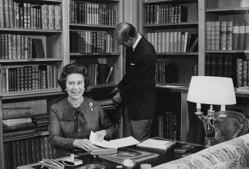 Queen Elizabeth II and the Duke of Edinburgh in the library at Balmoral during their traditional summer break.