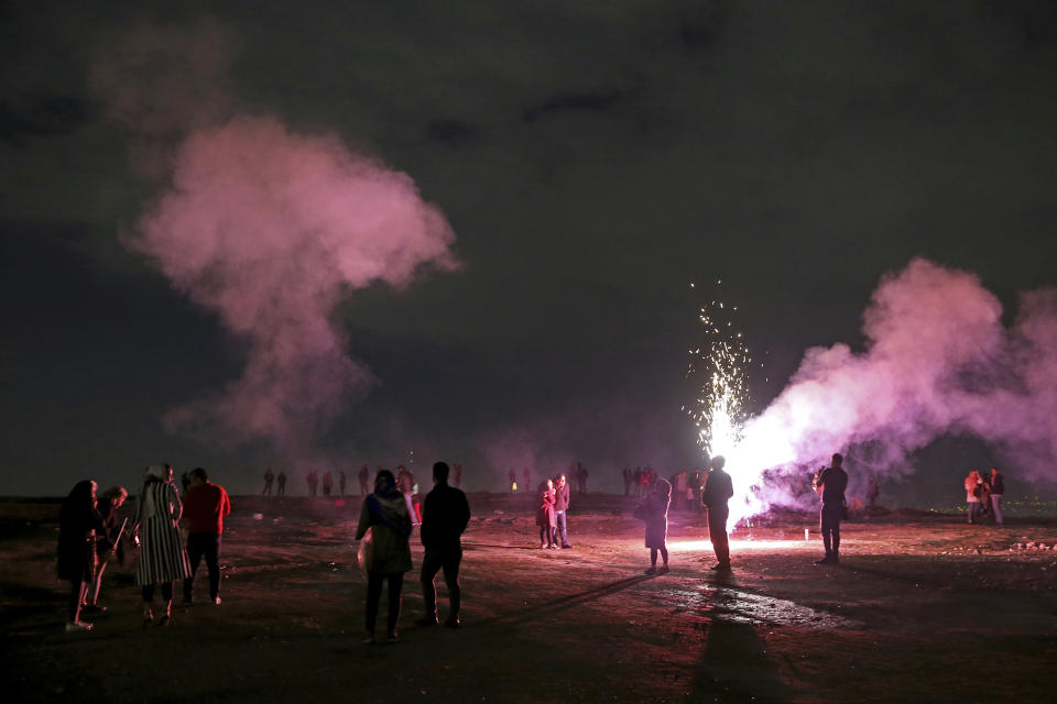 Iranians light fireworks during a celebration, known as "Chaharshanbe Souri," or Wednesday Feast, marking the eve of the last Wednesday of the solar Persian year, in in Tehran, Iran, Tuesday, March 19, 2019. Iran's many woes briefly went up in smoke on Tuesday as Iranians observed a nearly 4,000-year-old Persian tradition known as the Festival of Fire. (AP Photo/Ebrahim Noroozi)
