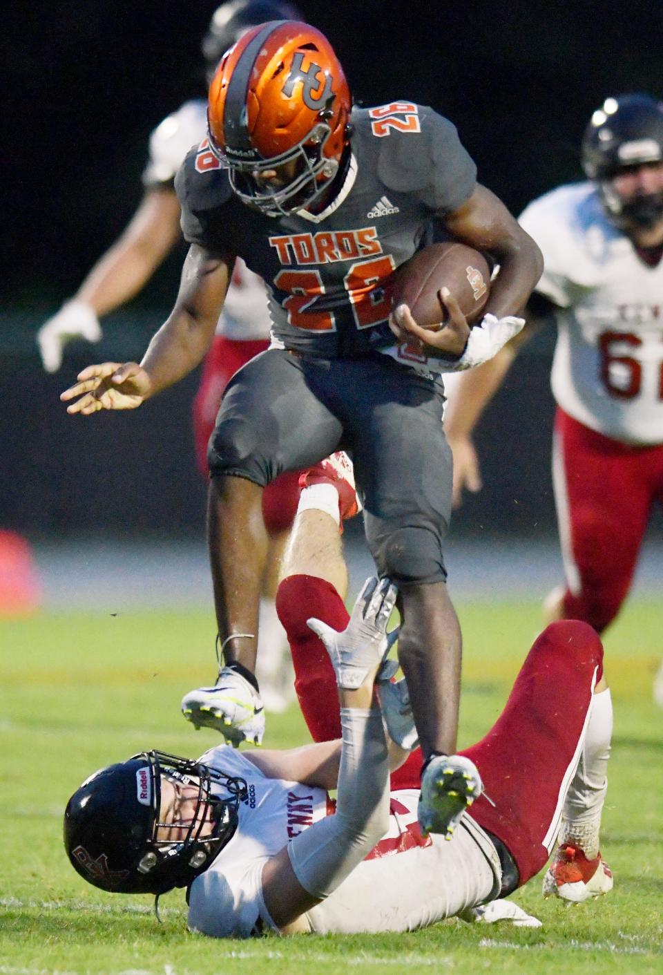 Tocoi's running back Wendell Dean (26) jumps over Bishop Kenny's Nash Beenen (17) on a late second quarter run for a first down. The Tocoi Creek Toros hosted the Bishop Kenny Crusaders at the school's Saint Johns County campus Friday, September 9, 2022.