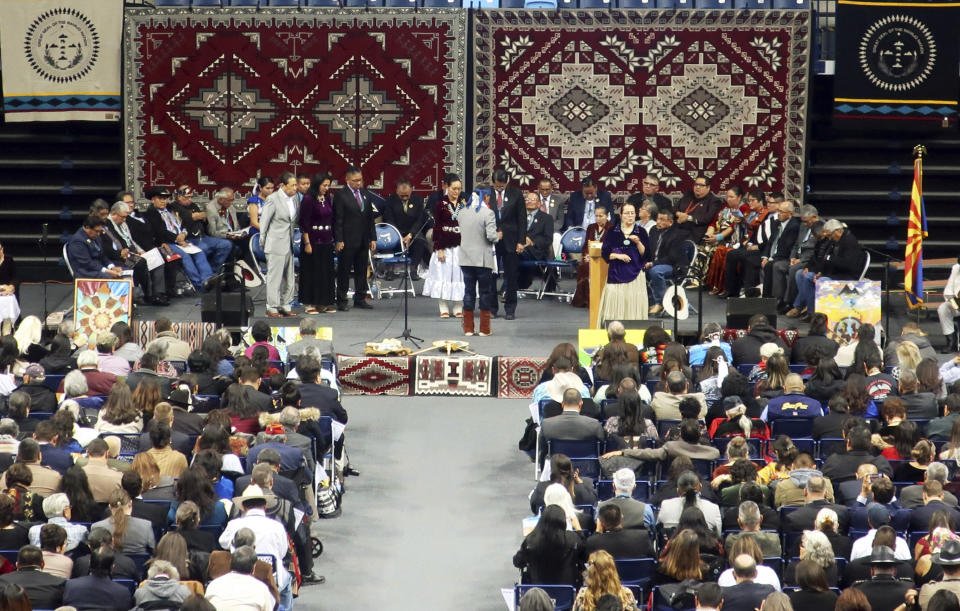 Navajo President Jonathan Nez and his wife, Phefelia, receive a blessing from a traditional practitioner during the tribe's inauguration Tuesday, Jan. 15, 2019, in Fort Defiance, Ariz. (AP Photo/Felicia Fonseca)