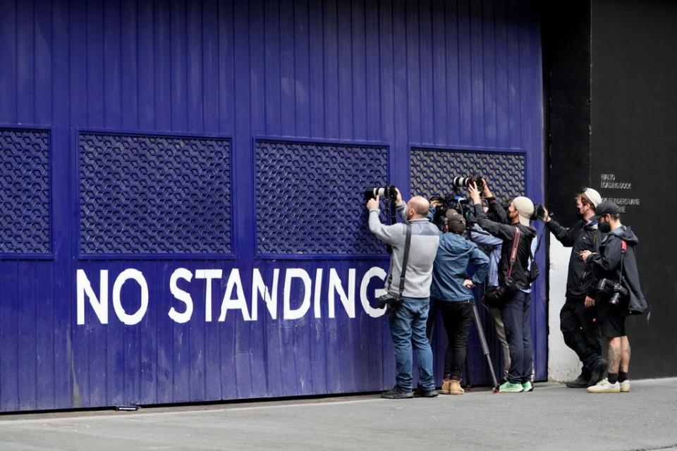 Photographers attempt to take pictures outside a building that houses the office of Novak Djokovic’s lawyers (Mark Baker/AP) (AP)