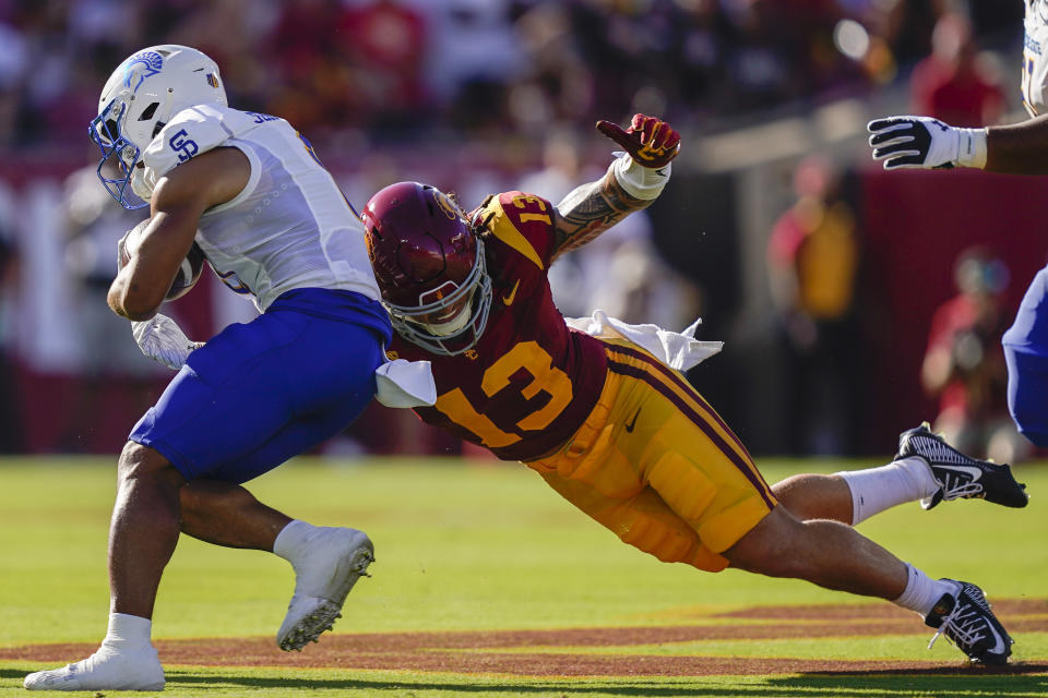 Southern California linebacker Mason Cobb (13) tackles San Jose State wide receiver Isaac Jernagin during the first half of an NCAA college football game Saturday, Aug. 26, 2023, in Los Angeles. (AP Photo/Ryan Sun)