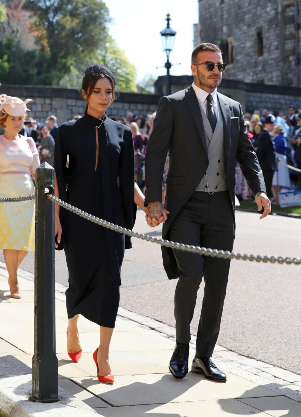 suited and booted: Victoria and David Beckham arrive (PA)