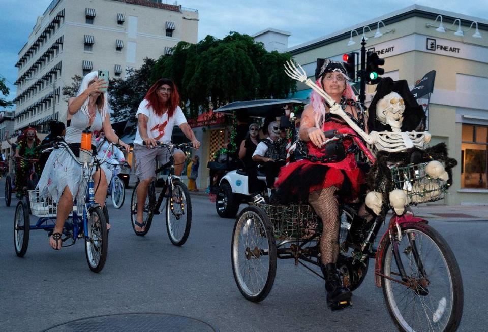 Costumed bicycle riders roll down Duval Street in Key West on Oct. 24, 2021. Although large-scale events were canceled due to the COVID-19 pandemic, the annual Fantasy Fest celebration continues through Sunday, Oct. 31.