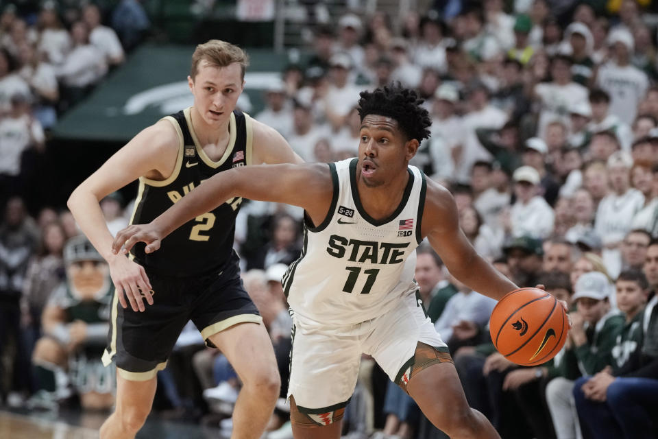 Michigan State guard A.J. Hoggard (11) derives past Purdue guard Fletcher Loyer (2) during the second half of an NCAA college basketball game, Monday, Jan. 16, 2023, in East Lansing, Mich. (AP Photo/Carlos Osorio)