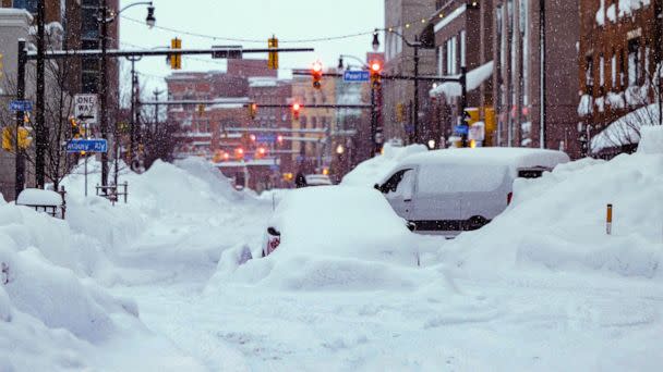 PHOTO: Vehicles are seen trapped under heavy snow in the streets of downtown Buffalo, New York, on December 26, 2022. (The Office of Governor Kathy Hochul/AFP via Getty Images)