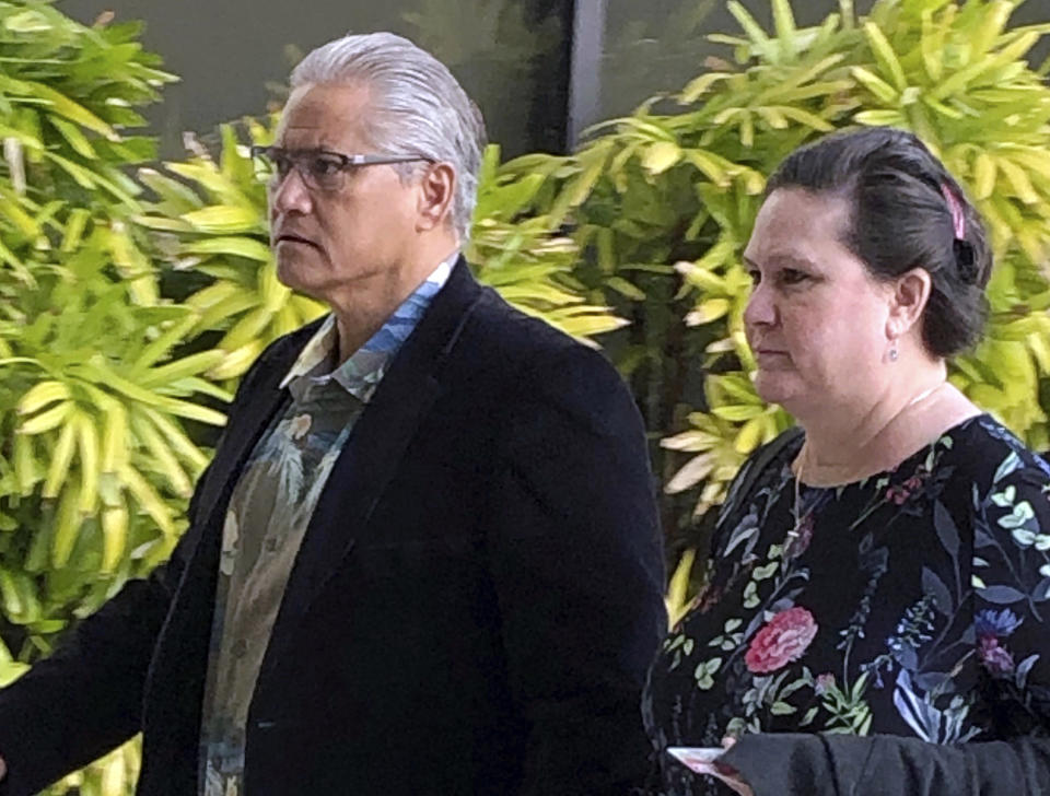 FILE - In this March 4, 2019 file photo, retired Honolulu police chief Louis Kealoha, and his wife, former deputy prosecutor Katherine Kealoha, walk into the U.S. courthouse in Honolulu. In closing arguments beginning Tuesday, June 25, prosecutors say the former Honolulu police chief and his wife, a former deputy prosecutor, abused their positions in an attempt to silence a relative who could have exposed the financial fraud that funded their lavish lifestyle. (AP Photo/Jennifer Sinco Kelleher, File)