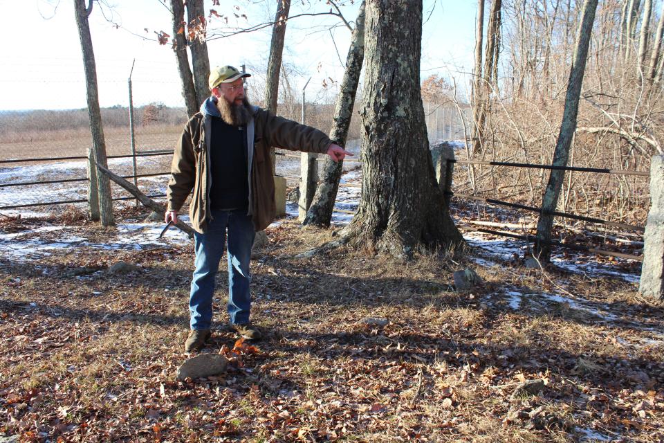 The Rev. Ken Postle checks on a forgotten cemetery on the Smithfield-Lincoln line near North Central State Airport.