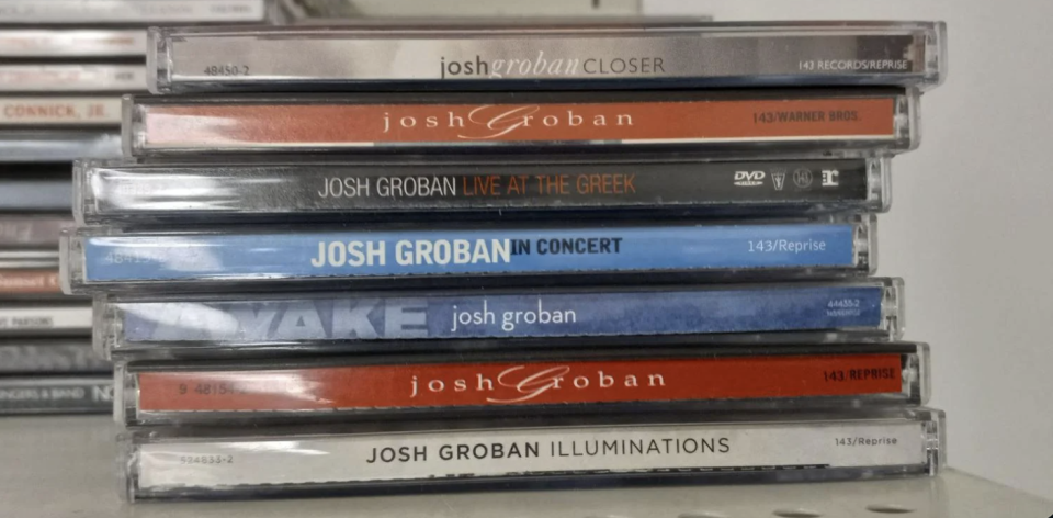 A stack of various Josh Groban CD albums