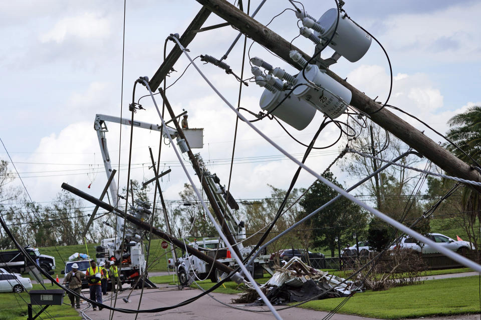 Crews begin work on downed power lines leading to a fire station, Tuesday, Aug. 31, 2021, in Waggaman, La., as residents try to recover from the effects of Hurricane Ida.Power out, high voltage lines on the ground, maybe weeks until electricity is restored in some places _ it's a distressingly familiar situation for Entergy Corp., Louisiana's largest electrical utility. Entergy is hardly alone. (AP Photo/Steve Helber)