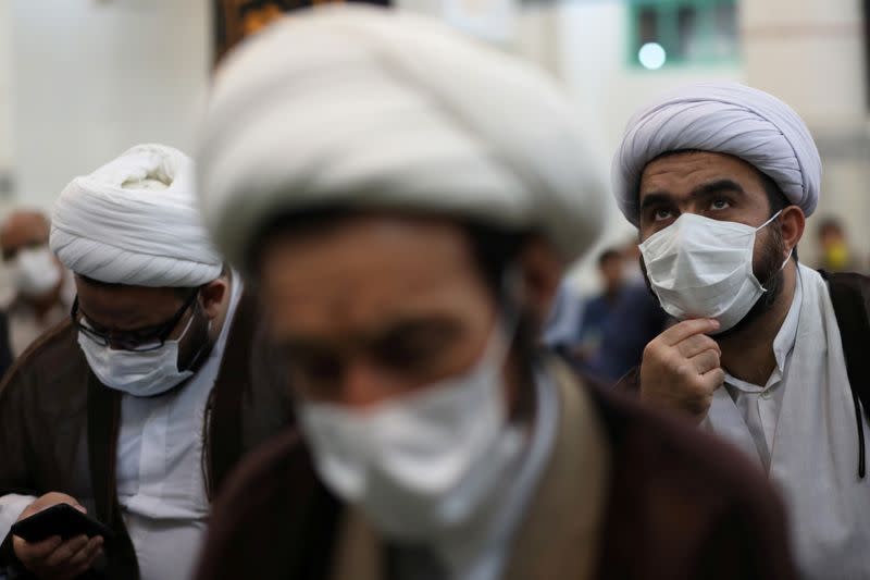 FILE PHOTO: Iranian clerics wearing protective face masks attend the Friday prayers in Qarchak Jamee Mosque, following the outbreak of the coronavirus disease (COVID-19), in Tehran province, in Qarchak