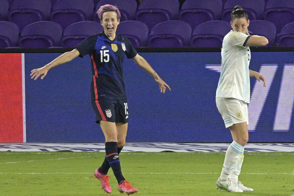 United States forward Megan Rapinoe (15) celebrates after scoring a goal in front of Argentina midfielder Vanesa Santana, right, during the first half of a SheBelieves Cup women's soccer match, Wednesday, Feb. 24, 2021, in Orlando, Fla. (AP Photo/Phelan M. Ebenhack)