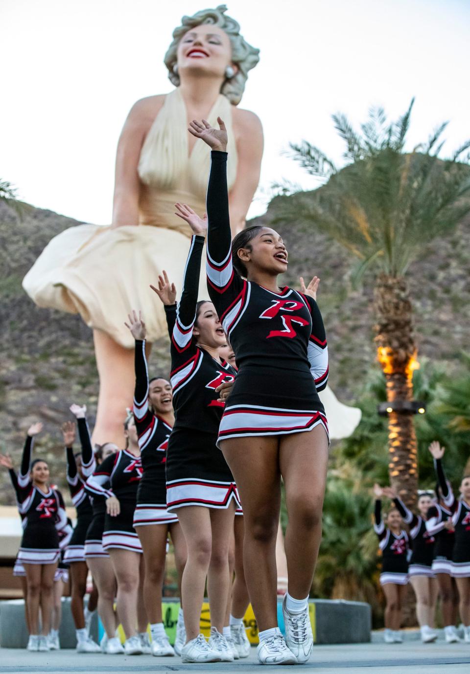 Palm Springs Cheer Co-Captain Candyce Reynolds, 17, performs with her squad in front of the Forever Marilyn statue while waiting for it to be lit up red in celebration of National Wear Red Day in an event organized by the Coachella Valley Heart Association in Palm Springs, Calif., Friday, Feb. 2, 2024.