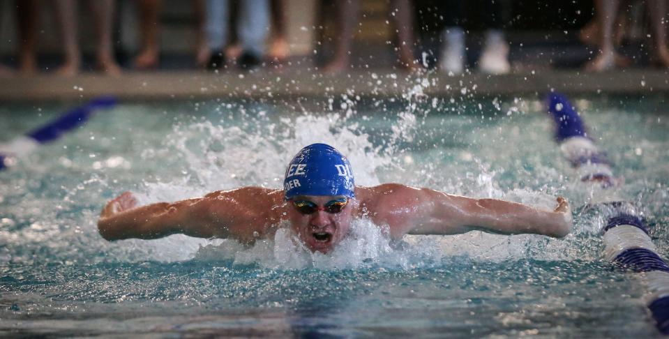 Dundee's Trevor Schroeder swims to a win in the 100-yard butterfly during the Monroe County Championship Saturday, February 4, 2023 at Dundee High School.