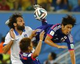Japan's Atsuto Uchida (R) is fouled by Greece's Giorgios Samaras (L) during their 2014 World Cup Group C soccer match at the Dunas arena in Natal June 19, 2014. REUTERS/Kai Pfaffenbach